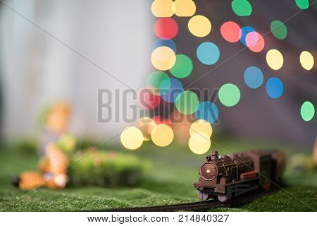 Model Train On Railway With Colorful Bokeh. Locomotive On Track Layout. Transpotation Miniature. Lei