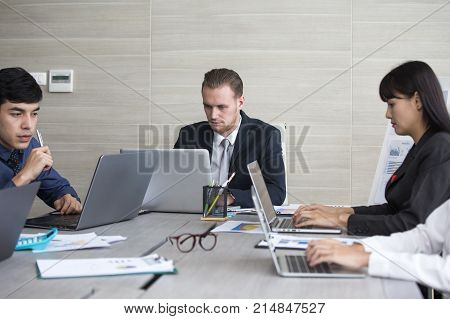 Young Business People Working Together With Serious Emotion. Business People Takling In Modern Offic