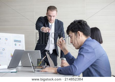 Young Business People Working Together With Serious Emotion. Business People Pointing To Team With A
