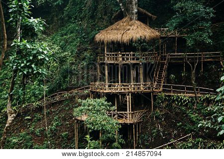 Wooden Bamboo Hovel House In Forest. Film Color Toned Filter