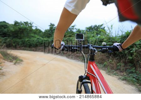 cyclist hands cycling mountain bike on trail