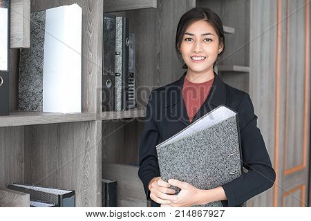 Asian Woman Holding Document At Working Place, Woman Working Concept.
