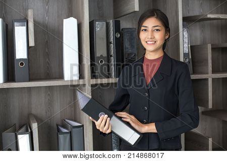 Asian Woman Holding Document At Working Place, Woman Working Concept.