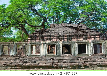 Phimai Historical And Ancient Stone Castle In Thailand And Big Tree
