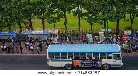 Chatuchak park, Bangkok,Thailand 10 Nov 2017 : People wait for bus at bus stop in front of Chatuchak park.

Chatuchak Park is the public park in Chatuchak distric,Bangkok,Opened on 
1980