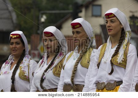 SARAJEVO, BOSNIA AND HERZEGOVINA - AUGUST 20 2017: Group of traditional dressed bosnian girls in front of Sebilj fountain holding tambourines