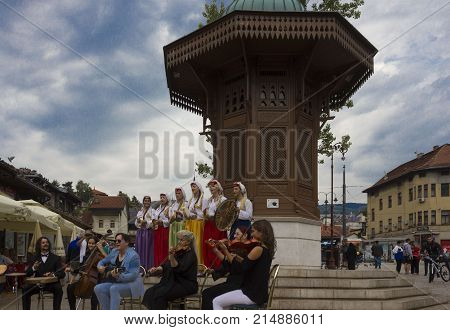 SARAJEVO, BOSNIA AND HERZEGOVINA - AUGUST 20 2017: Traditional Bosnian musician band in ethnic clothing in front of the Sebilj fountain on Bascarsija city centre in Sarajevo