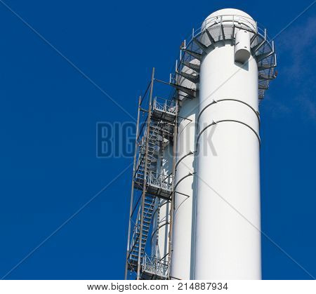 Cooling triple towers of heating plant plant against the blue sky