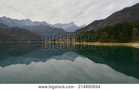 Autumn at Lake Barcis in Friuli Venezia Giulia north east Italy with the Italian Alps in the background