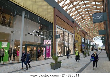 Bracknell, England - Nov 22, 2017: People passing by various retail stores in the Lexicon shopping center, opened in 2017 as part of the ongoing redevelopment of Bracknell Town in England