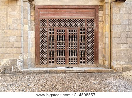 Wooden ornate door over stone brick wall Old Cairo Egypt