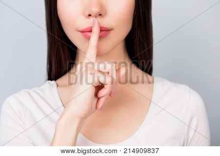 Shhh! Close Up Portrait Of Half Face Of Young Woman With  Finger Showing Hush Silence Sign, Gesture