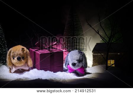 Toy Dog - A Symbol Of The New Year Under The Snow Against The Background Of Fir Branches. Toy's Dog 