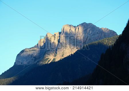The view of mountain massif at sunset light.