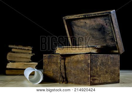 Old Rolls And Plans In Folded Paper Rolls. Old Book And Case. Documents On An Old Wooden Table.
