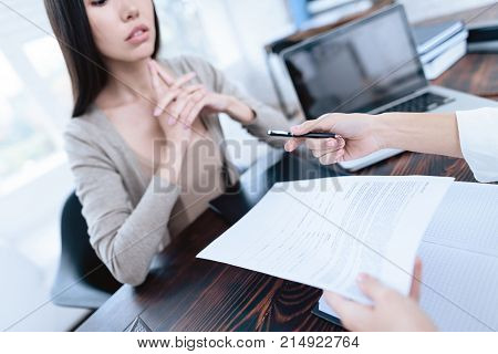 The couple went to a lawyer to conclude an agreement on the divorce. They quarrel and argue with each other. Lawyer prepares documents.
