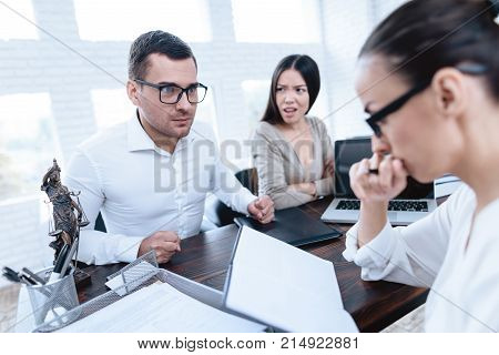 The couple went to a lawyer to conclude an agreement on the divorce. They quarrel and argue with each other. Lawyer prepares documents.