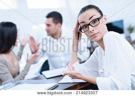 The couple went to a lawyer to conclude an agreement on the divorce. They quarrel and argue with each other. Lawyer prepares documents.