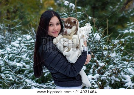Close up happy woman owner and husky dog in winter day.