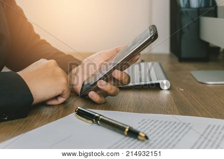 Business woman use mobliephone for check detail with documents before signing terms and conditions business signing concept