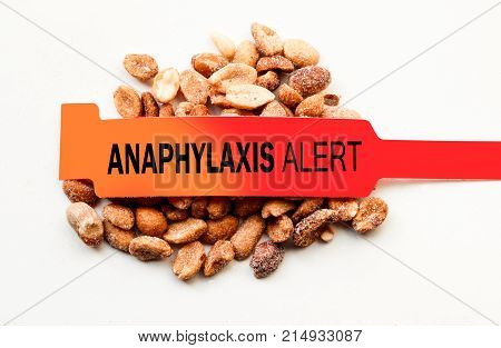 Anaphylaxis alert bracelet on top of peanuts