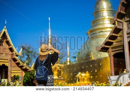 Young Woman Traveler Traveling To Wat Phra Singh Temple. This Temple Contains Supreme Examples Of La