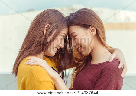 LGBT lesbian women couple moments happiness. Lesbian women couple together outdoors concept. Lesbian couple embraced together relation fall in love. Two asian women having fun together at rooftop.