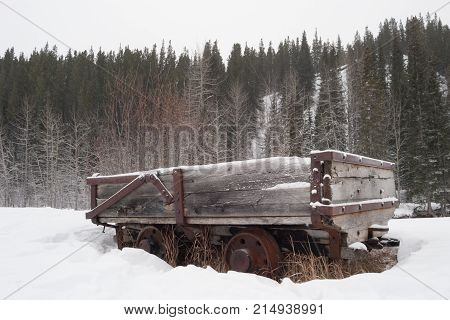 Old abandoned coal car in the winter forest, Kananaskis