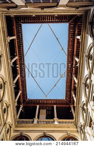 Florence, Italy - August 23, 2016: Low angle view of the courtyard of Palazzo Strozzi in Florence. It is a renaissance palace and an example of civil architecture with its rusticated stone.