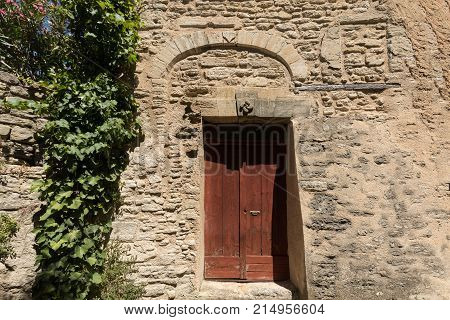 Old wooden door on stone house in Gordes. Provence France