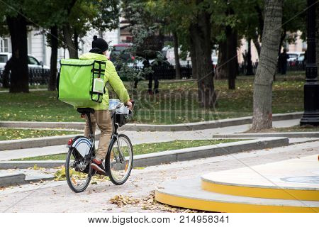 delivery man on the bike in the city roadway