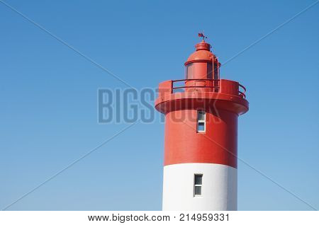 Lighthouse at Unhlanga Rocks in Durban South Africa painted a distinct red and white and managed by the Oyster Box Hotel since 1954