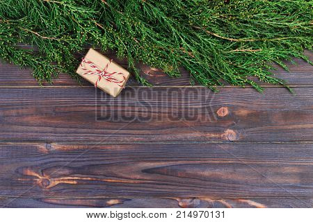Black wooden christmas background. twigs of thuja. Original fresh floral design for xmas card. empty space for holiday greetings.