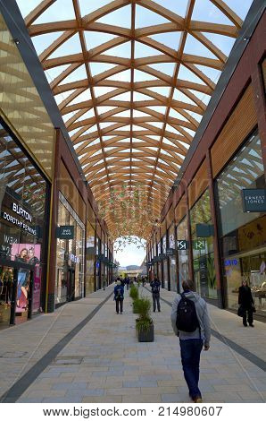 Bracknell, England - Nov 22, 2017: People passing by various retail stores in the Lexicon shopping center, opened in 2017 as part of the ongoing redevelopment of Bracknell Town in England
