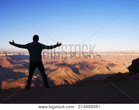 Man From The Rear Standing With Outstretched Arms Overlooking Th