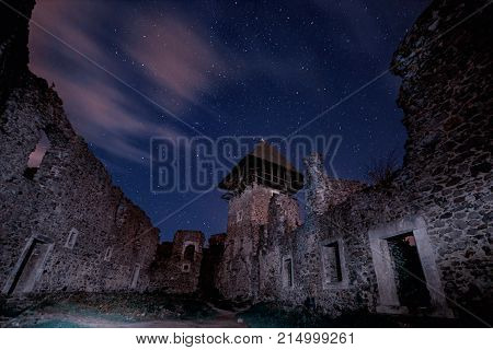 Ruins of  Castle near Uzhgorod, Ukraine with a lot of shiny stars on the dark blue sky