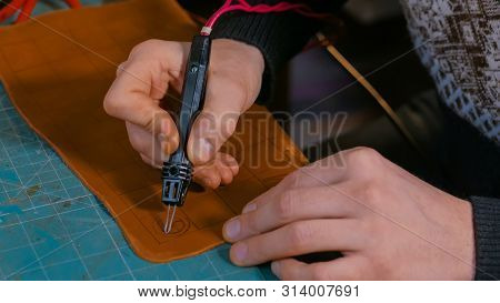 Professional Male Skinner, Tanner Making Decorative Details On Leather Playing Field For Strategy Bo