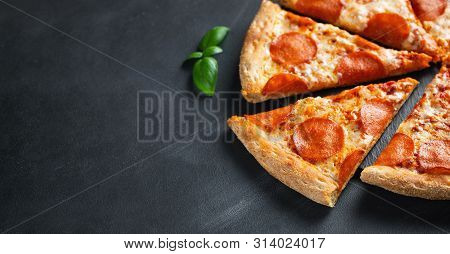 Tasty Pepperoni Pizza On Black Concrete Background. Top View Of Hot Pepperoni Pizza. With Copy Space