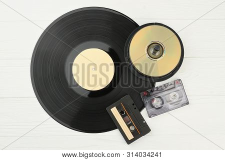 Vinyl Plate, Dvd Discs And Audio Tapes. Gramophone Record, Compact Disks And Audio Cassettes On Whit