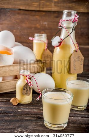 Traditional Italian Vov Eggs Liquor. German Egg Liqueur Eierlikor. In Different Bottle And Shot Glas
