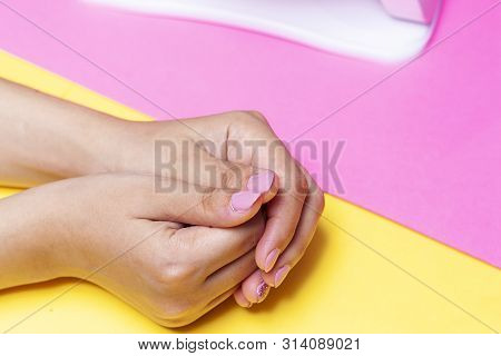 A Young Woman Manicured Hands After Procedure. Pretty Girl Using Shellac Uv Led Lamp. Concept Of Nai
