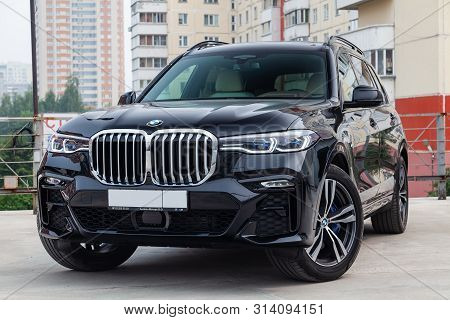 Novosibirsk, Russia - 07.20.2019: Black New Bmw X7 Xdrive40i 2019 Year Front View With Light Gray In