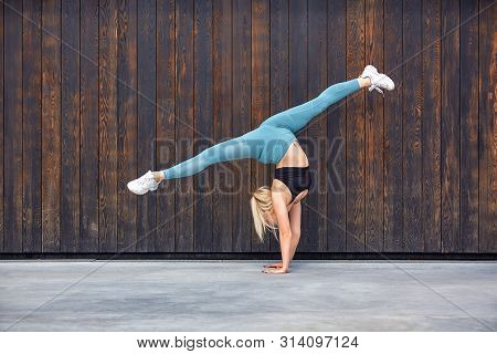 Beautiful Athletic Young Girl Gymnast In Sportswear, Working Out, Element Of Gymnastics, Doing The S