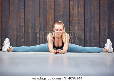 Beautiful Athletic Young Girl Gymnast In Sportswear, Working Out, Element Of Gymnastics, Doing The S