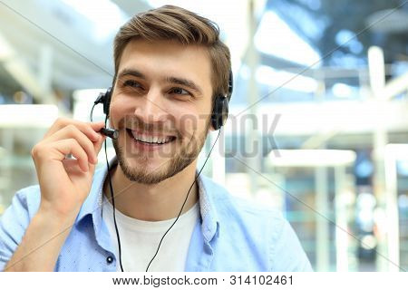 Smiling Friendly Handsome Young Male Call Centre Operator.
