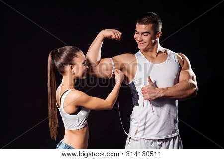 Muscular Athlete Shows Thumb-up. Bodybuilding Couple On Dark Background. Sportsman Has Excellent Res