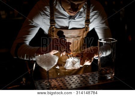 Bartender Crushing An Ice Cube With Crusher