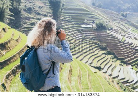 Young Caucasian Blonde Woman In Denim Shirt Taking Pictures Of Sapa Rice Terraces At Sunset In Lao C