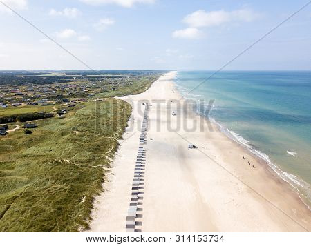 Lokken, Denmark - July 18, 2019: Aerial Drone View Of Lokken Beach With Cars And Beach Huts.