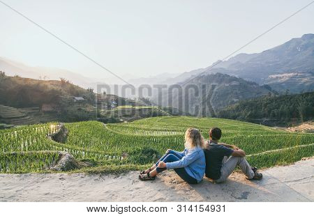Young Caucasian Couple Overlooking Rice Terraces Of Sapa At Sunset In Lao Cai Region Of Vietnam